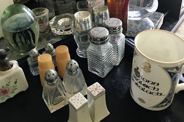 Various salt-and-pepper shakers and other kitchenalia on a table