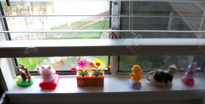 Photo of several toy items in a window sill