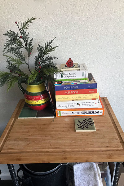 Photo of top of microwave stand with books